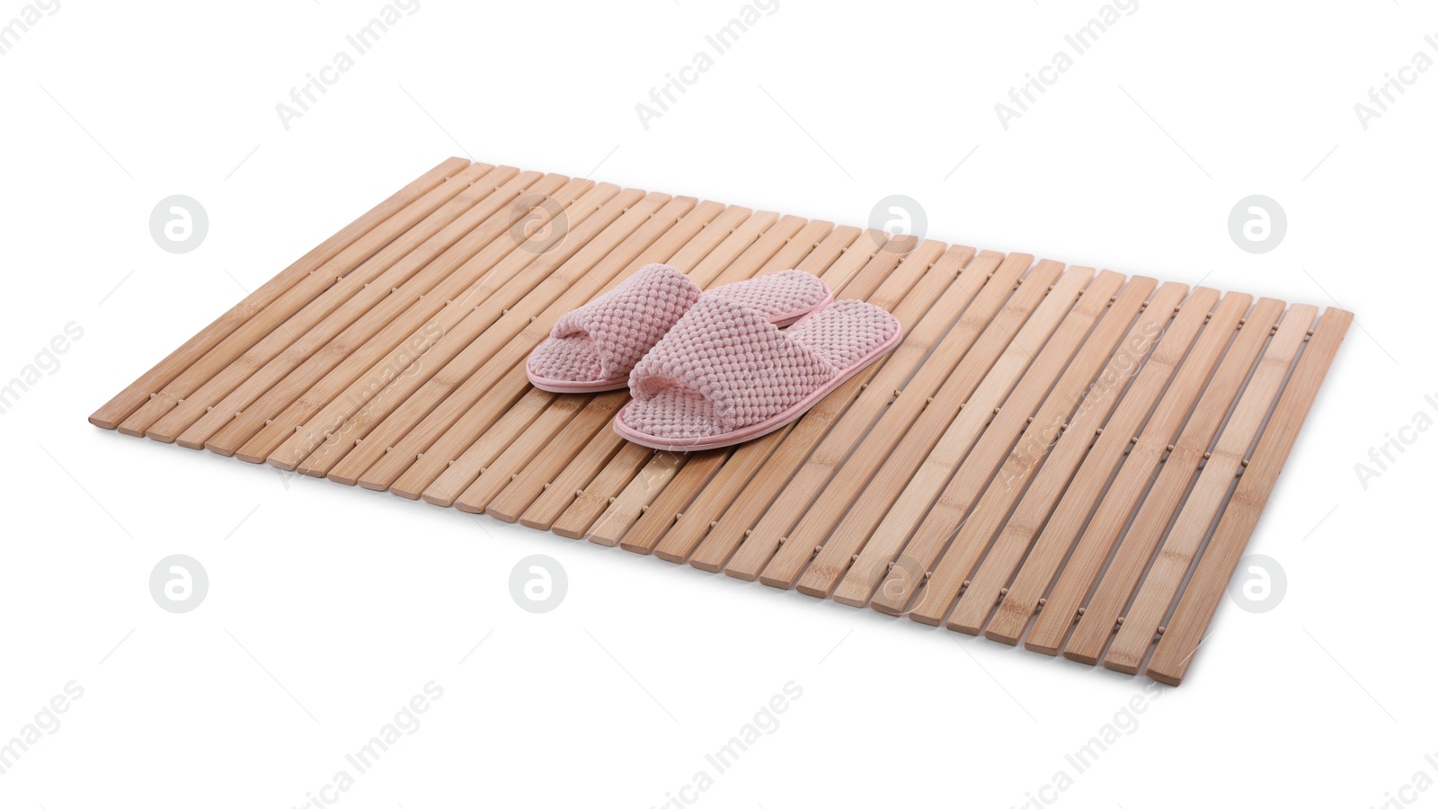 Photo of Bamboo rug with soft slippers isolated on white. Bath accessory