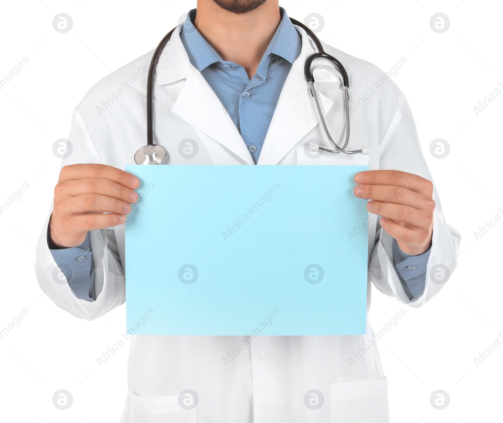 Photo of Male doctor holding blank sheet of paper on white background