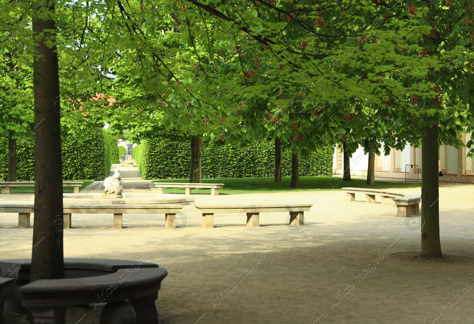 Photo of PRAGUE, CZECH REPUBLIC - APRIL 25, 2019: Stone benches around fountain in beautiful garden of Wallenstein Palace