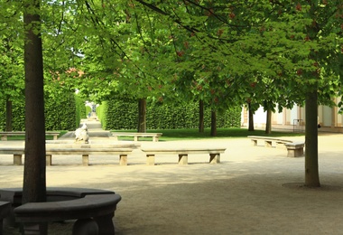 PRAGUE, CZECH REPUBLIC - APRIL 25, 2019: Stone benches around fountain in beautiful garden of Wallenstein Palace