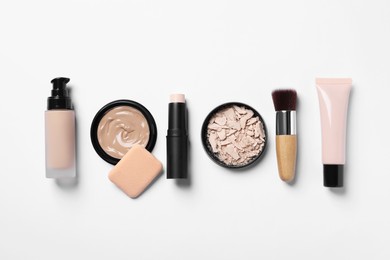 Foundation, beauty accessories and face powder on white background, flat lay
