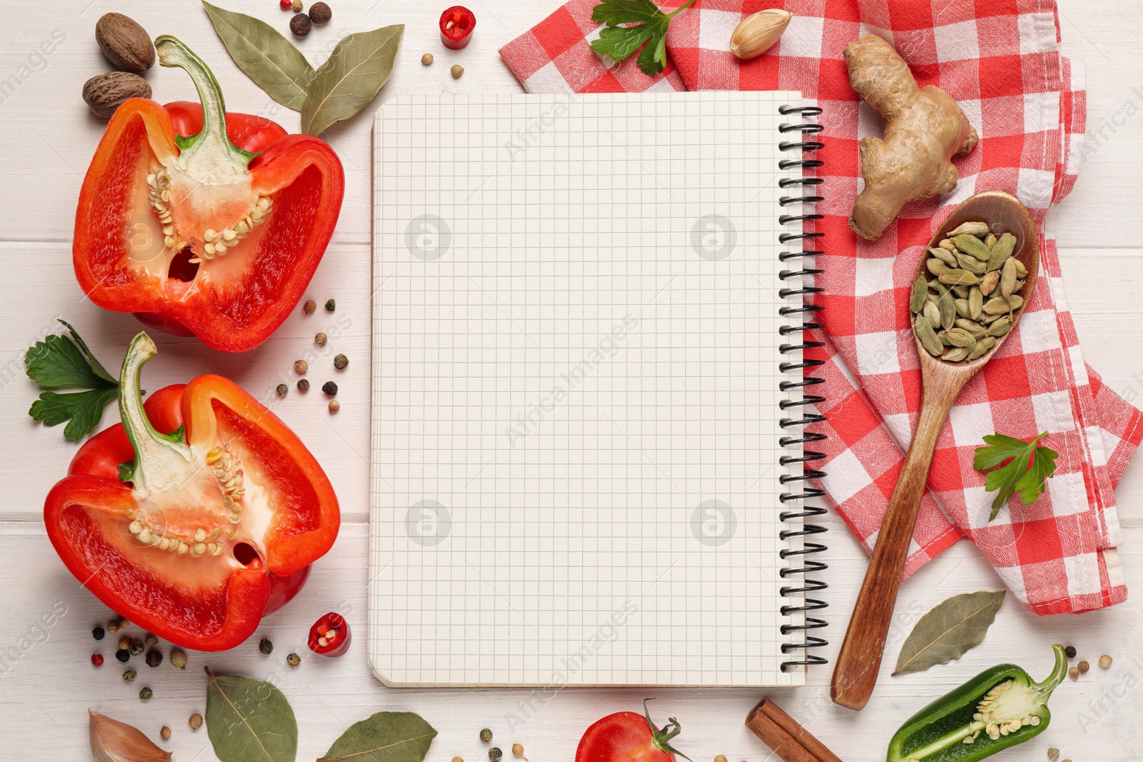 Photo of Blank recipe book and different ingredients on white wooden table, flat lay. Space for text