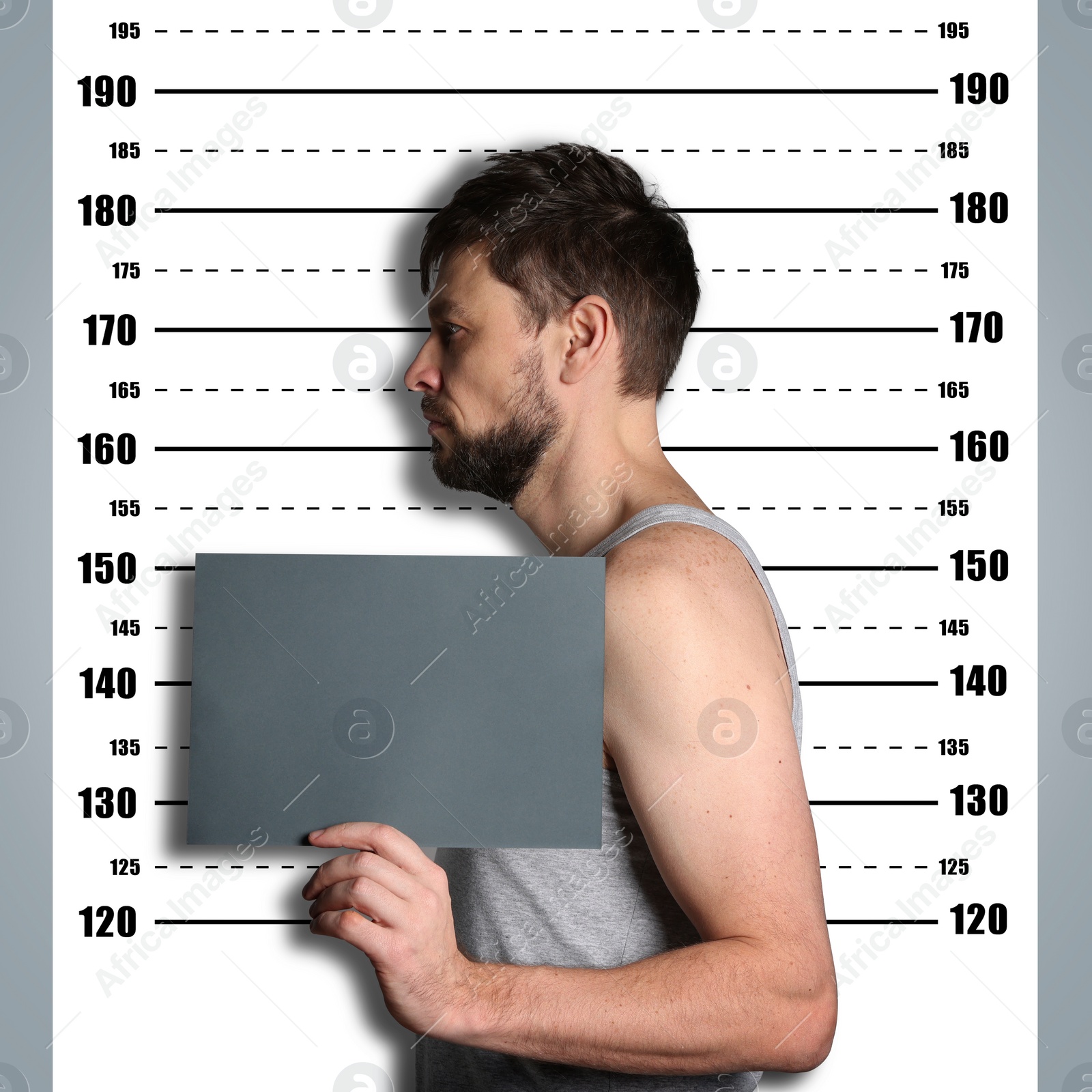 Image of Criminal mugshot. Arrested man with blank card against height chart