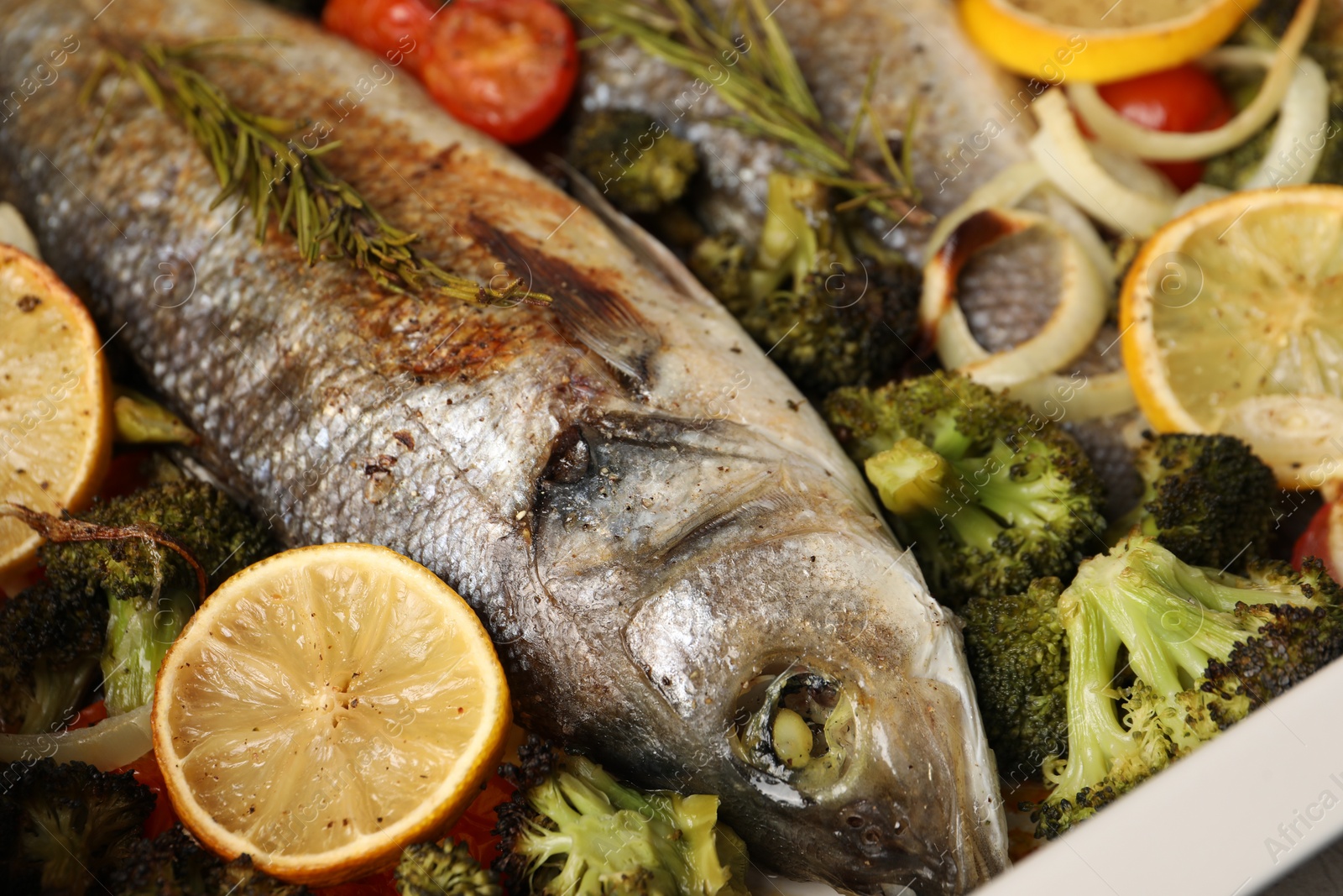 Photo of Delicious fish with vegetables and lemon, closeup