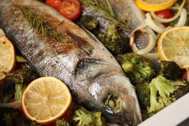 Photo of Delicious fish with vegetables and lemon, closeup