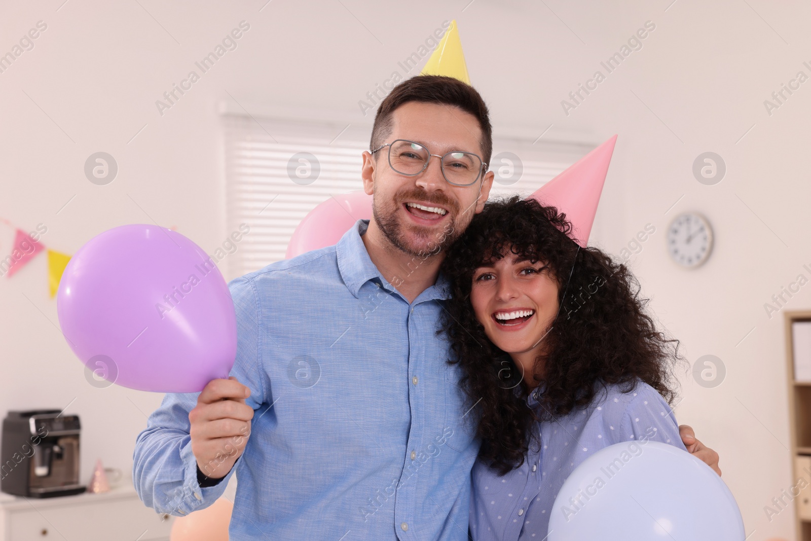 Photo of Coworkers having fun during office party indoors