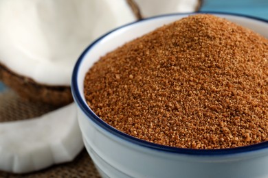 Photo of Natural coconut sugar in ceramic bowl, closeup