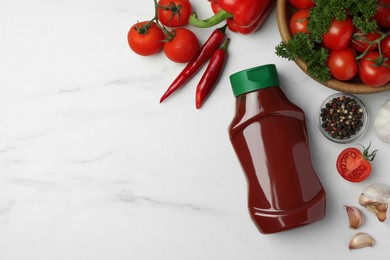 Photo of Bottle of tasty ketchup and ingredients on white marble table, flat lay. Space for text
