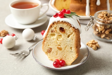 Composition with piece of traditional homemade Christmas cake on light grey table, closeup