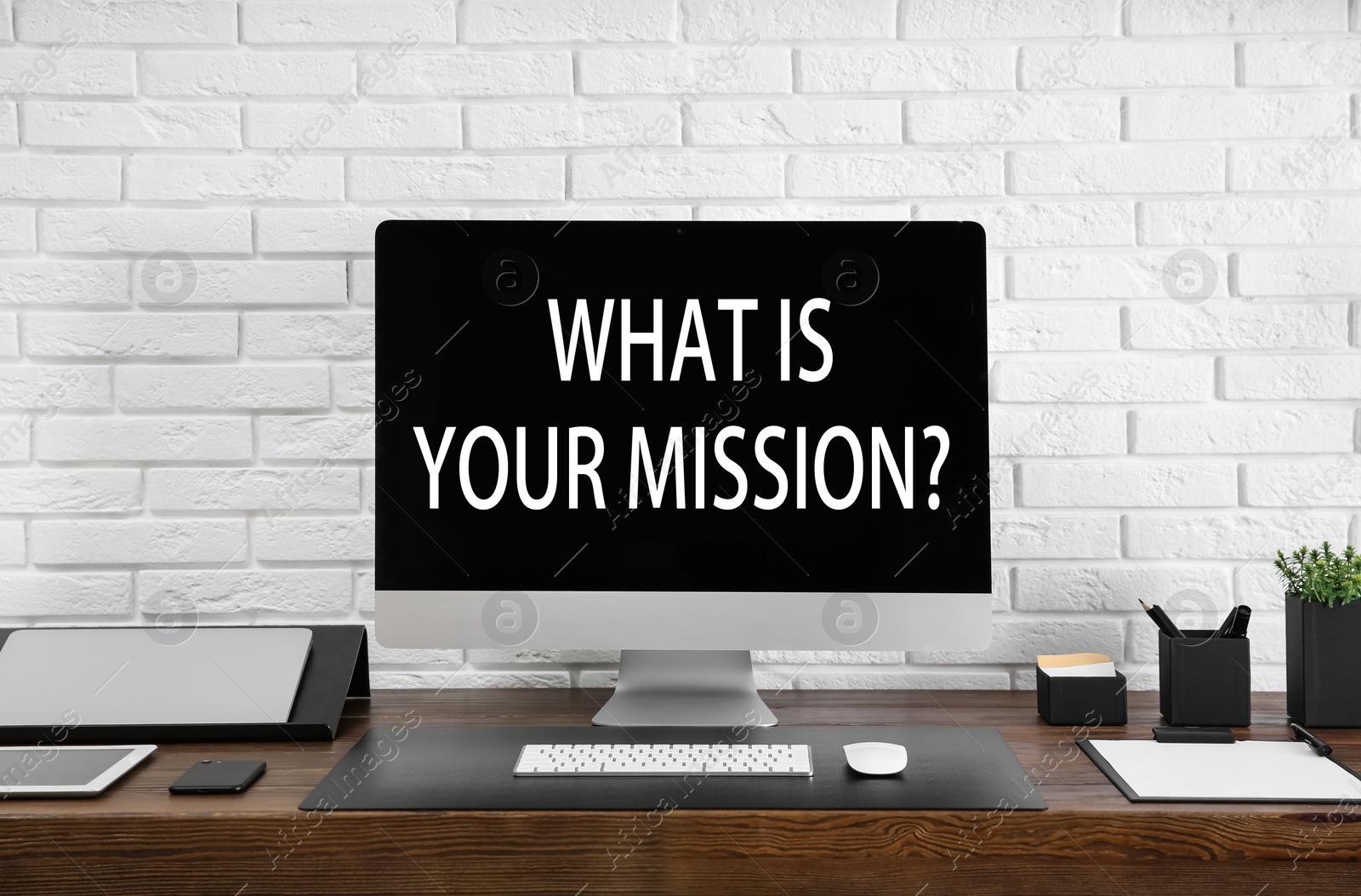 Image of Modern computer with question WHAT IS YOUR MISSION? on screen indoors 