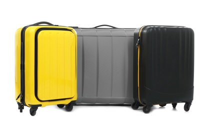 New suitcases packed for journey on white background