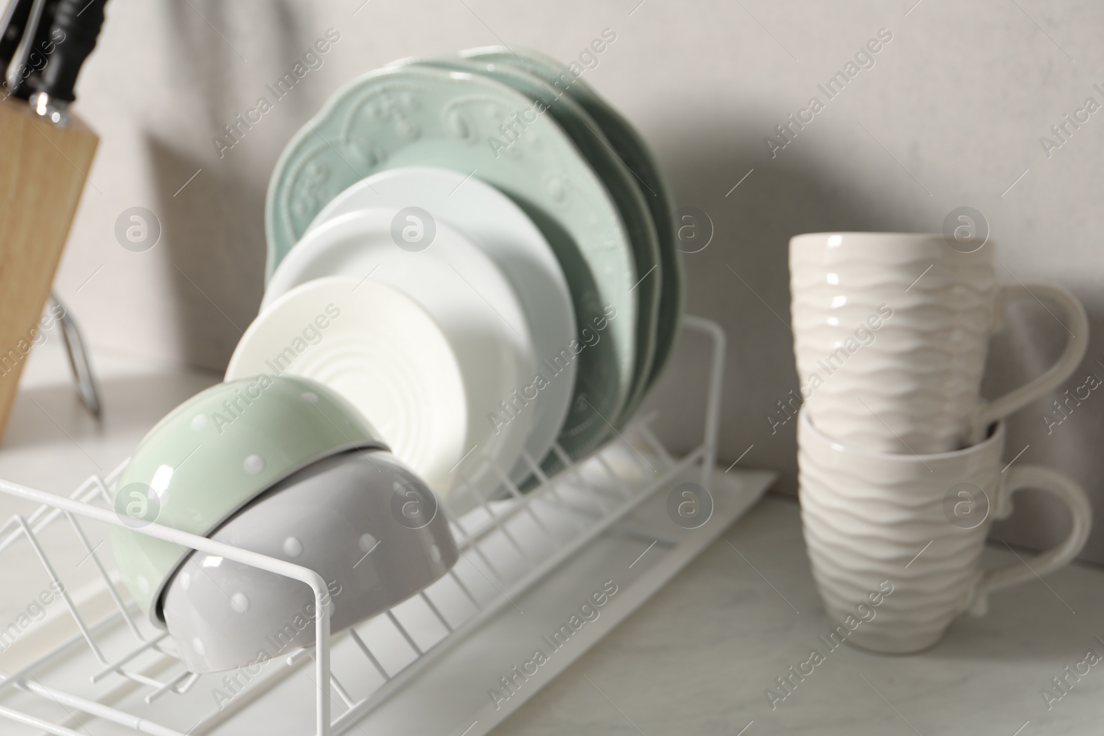 Photo of Many different clean dishware and cups on white table indoors