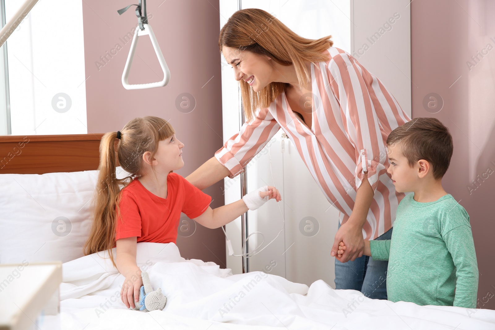 Photo of Happy family visiting little child in hospital