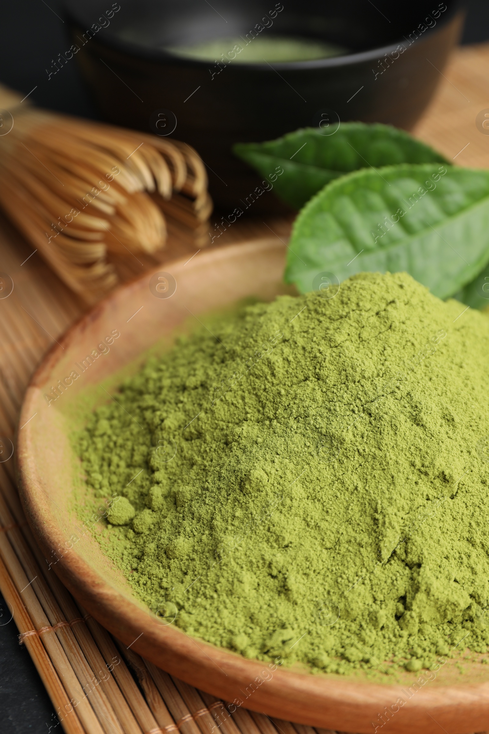 Photo of Green matcha powder on bamboo mat, closeup