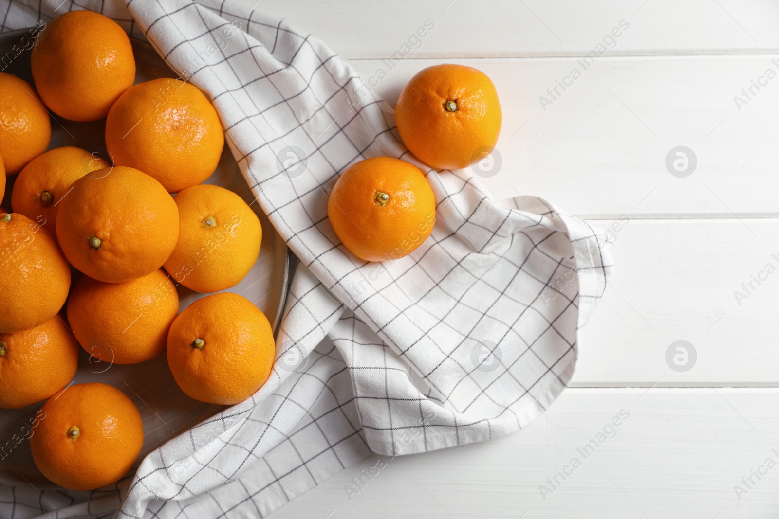 Photo of Many fresh ripe tangerines on white wooden table, flat lay. Space for text