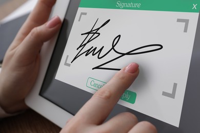 Image of Electronic signature. Woman using tablet, closeup view