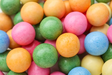 Photo of Many bright chewy gumballs as background, top view