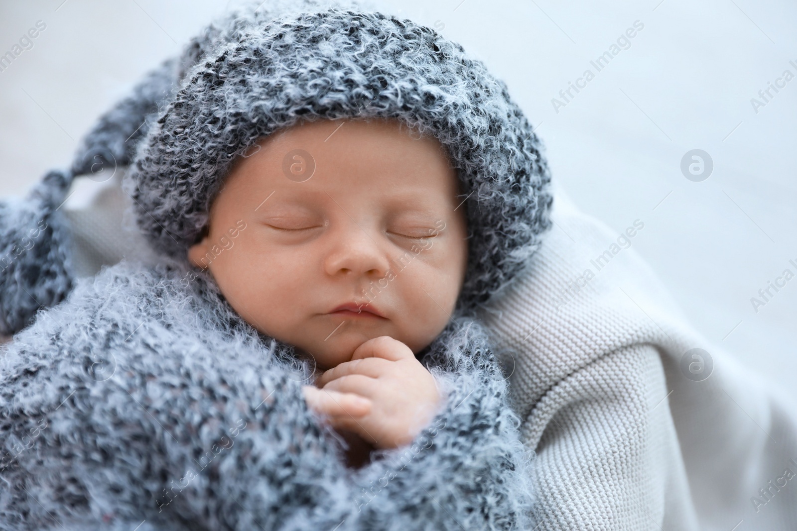 Photo of Cute newborn baby sleeping on plaid, top view