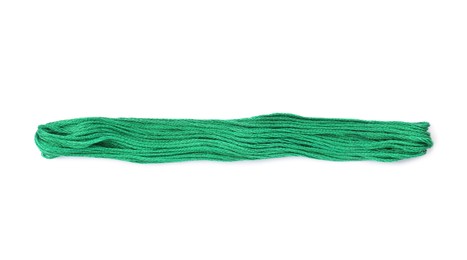 Bright green embroidery thread on white background