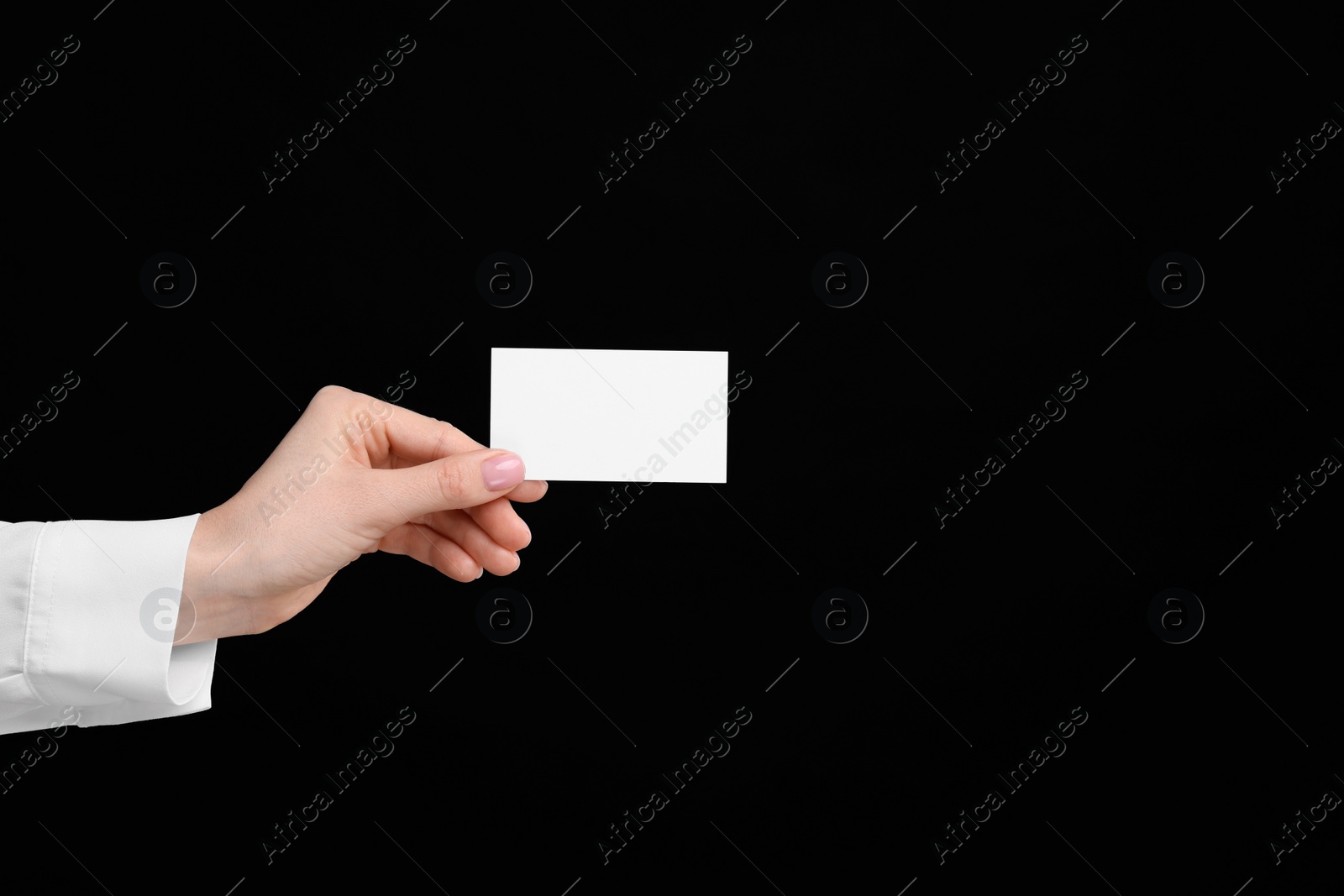 Photo of Woman holding blank business card on black background, closeup. Space for text