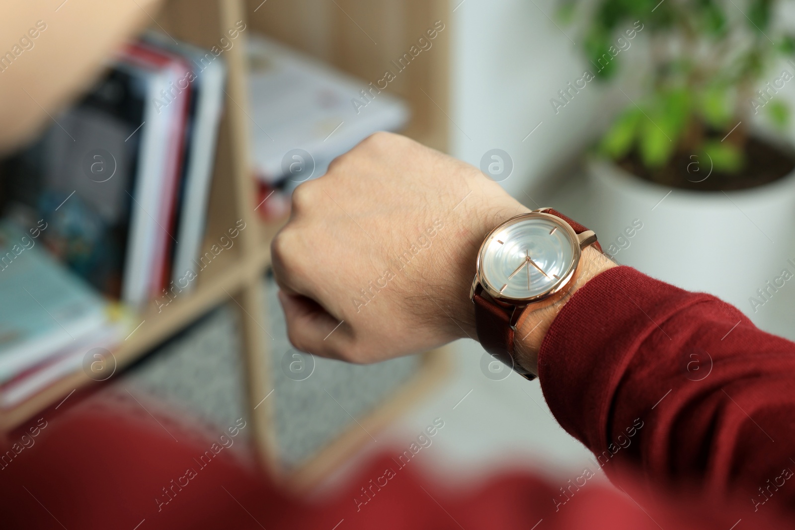 Photo of Man checking time in room, closeup. Being late