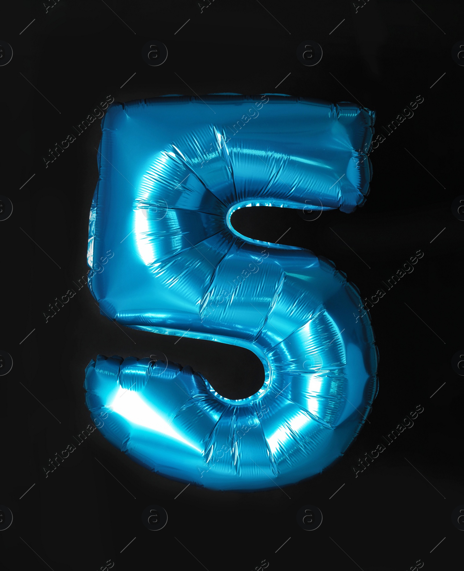 Photo of Blue number five balloon on black background