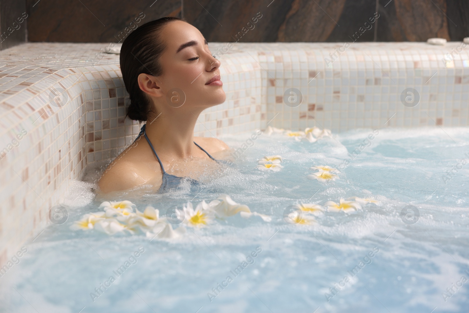 Photo of Beautiful woman relaxing in spa swimming pool, space for text