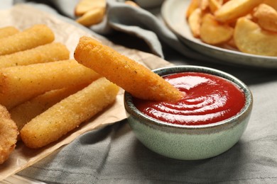Photo of Delicious cheese sticks and ketchup on table, closeup