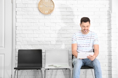 Photo of Young man waiting for job interview, indoors