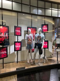 Photo of WARSAW, POLAND - JULY 17, 2022: Medicine store display with clothes on mannequins in shopping mall