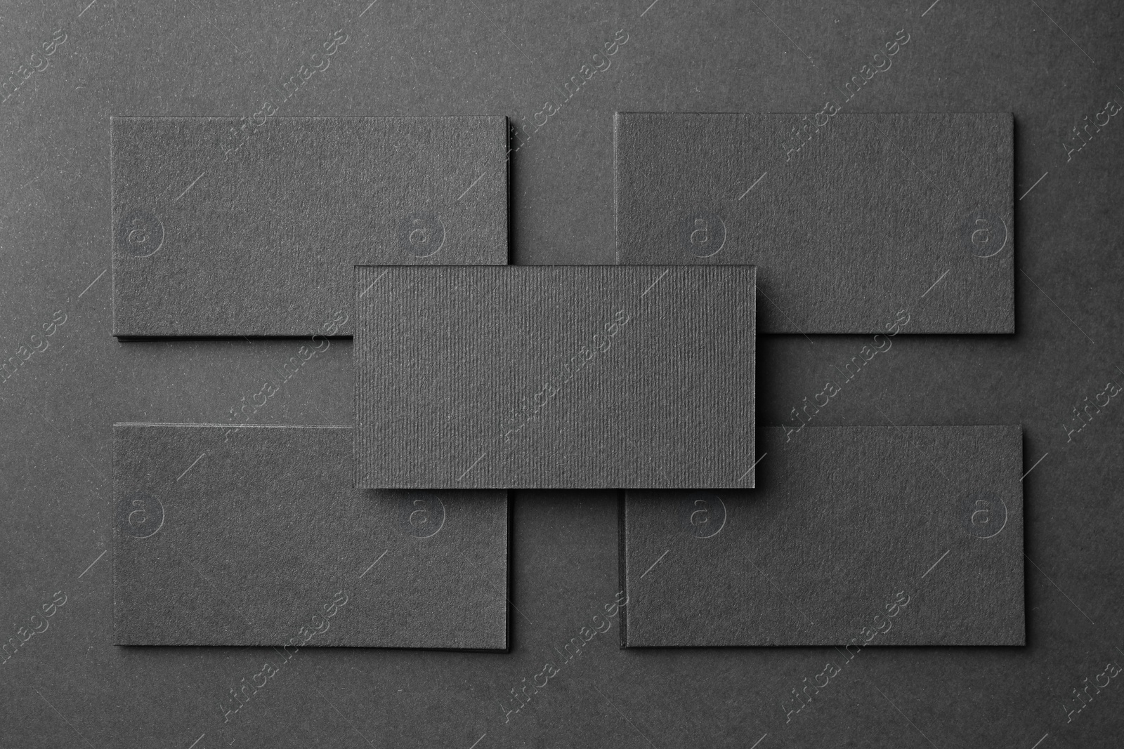 Photo of Blank business cards on black background, flat lay. Mockup for design