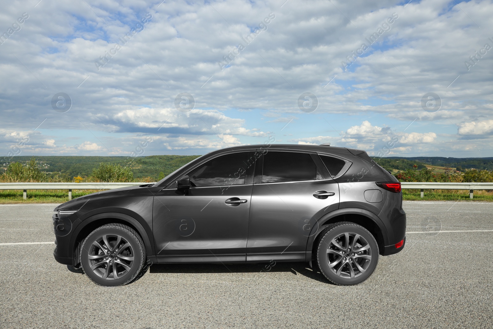 Photo of New black modern car on asphalt road