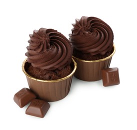 Photo of Delicious cupcakes and chocolate pieces isolated on white