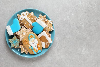 Photo of Tasty gingerbread cookies and space for text on light grey table, top view. St. Nicholas Day celebration