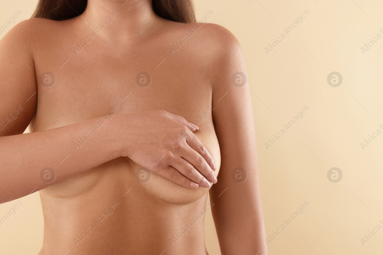 Image of Woman with breast asymmetry on beige background, closeup. Space for text