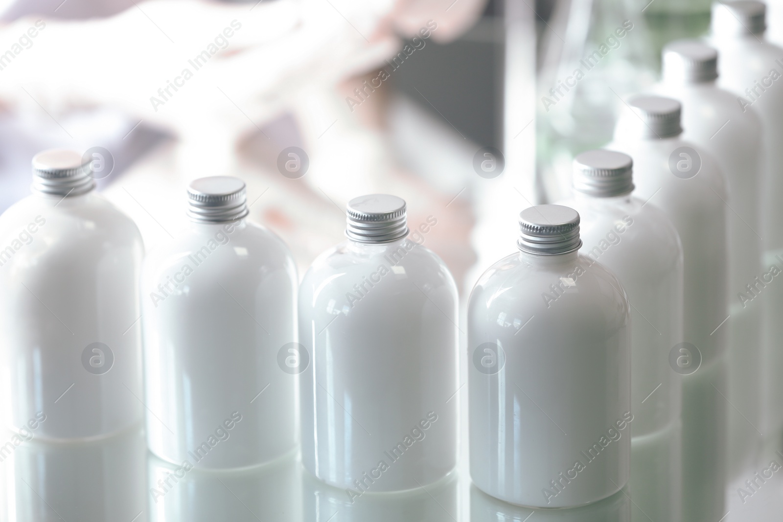 Photo of Many bottles with cosmetic product in laboratory