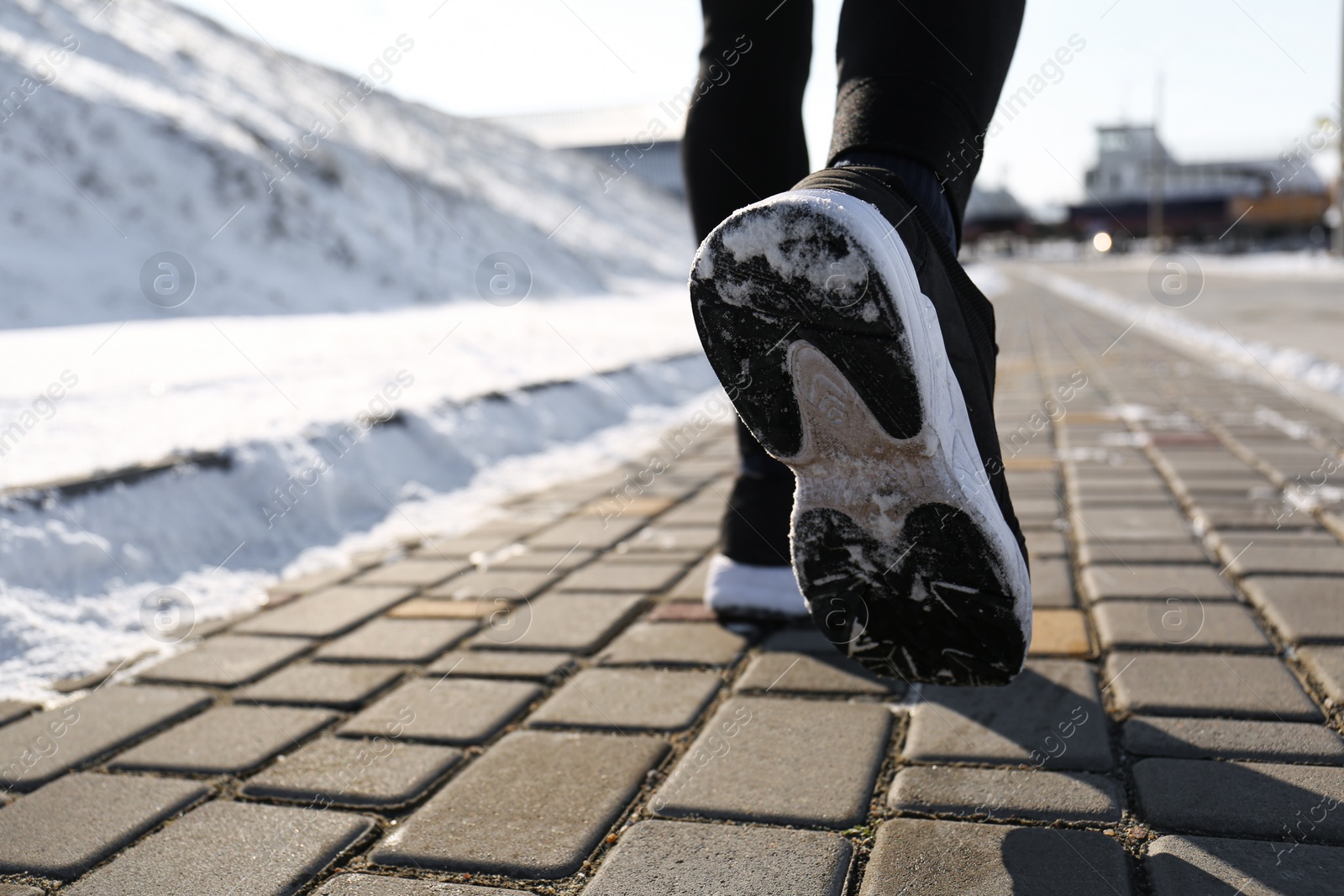 Photo of Man running outdoors on winter day, closeup. Sports exercises