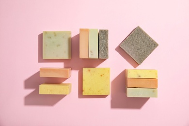 Hand made soap bars on color background, top view