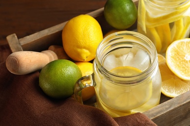 Mason jars with natural lemonade in wooden crate