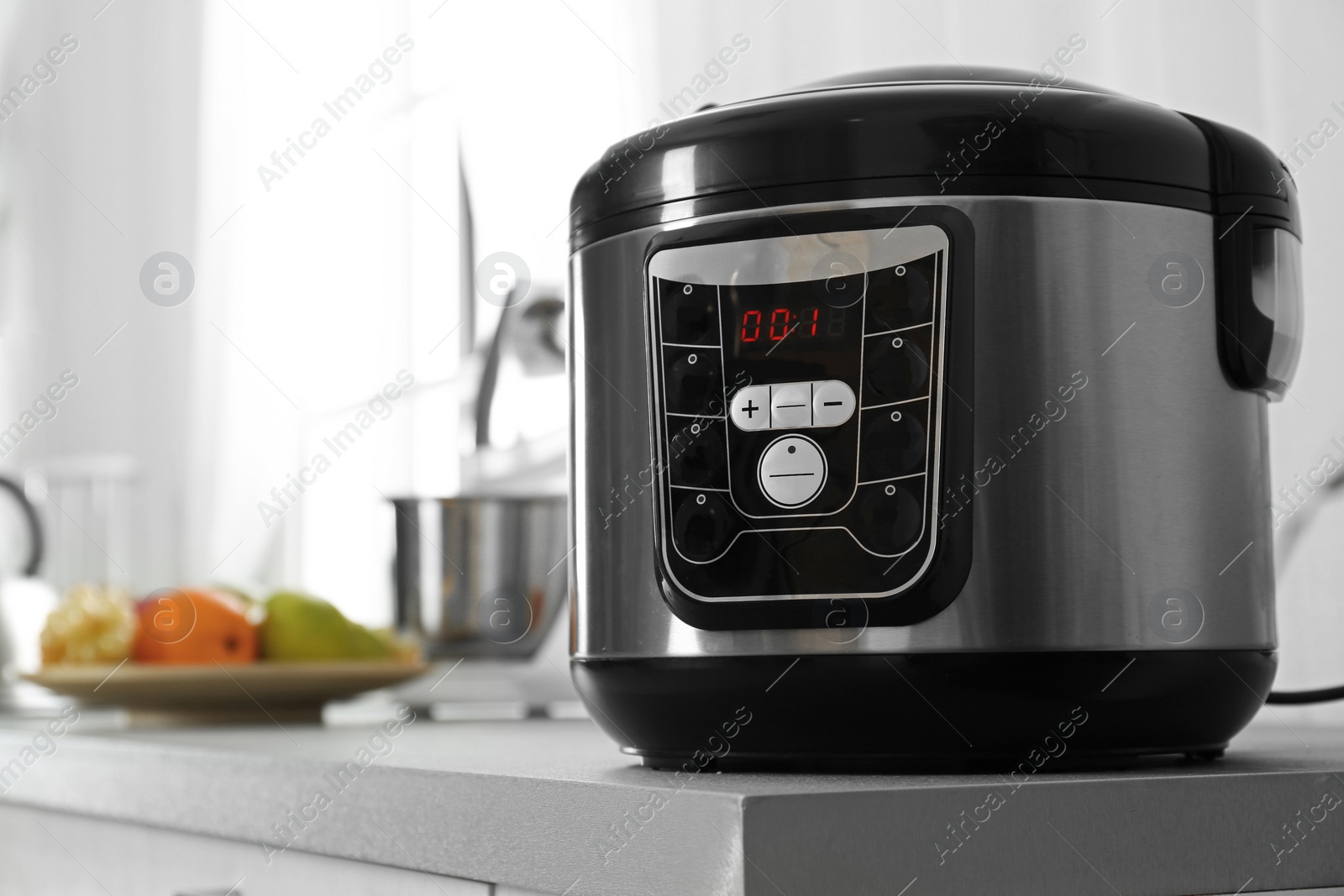 Photo of Modern multi cooker on table in kitchen. Space for text