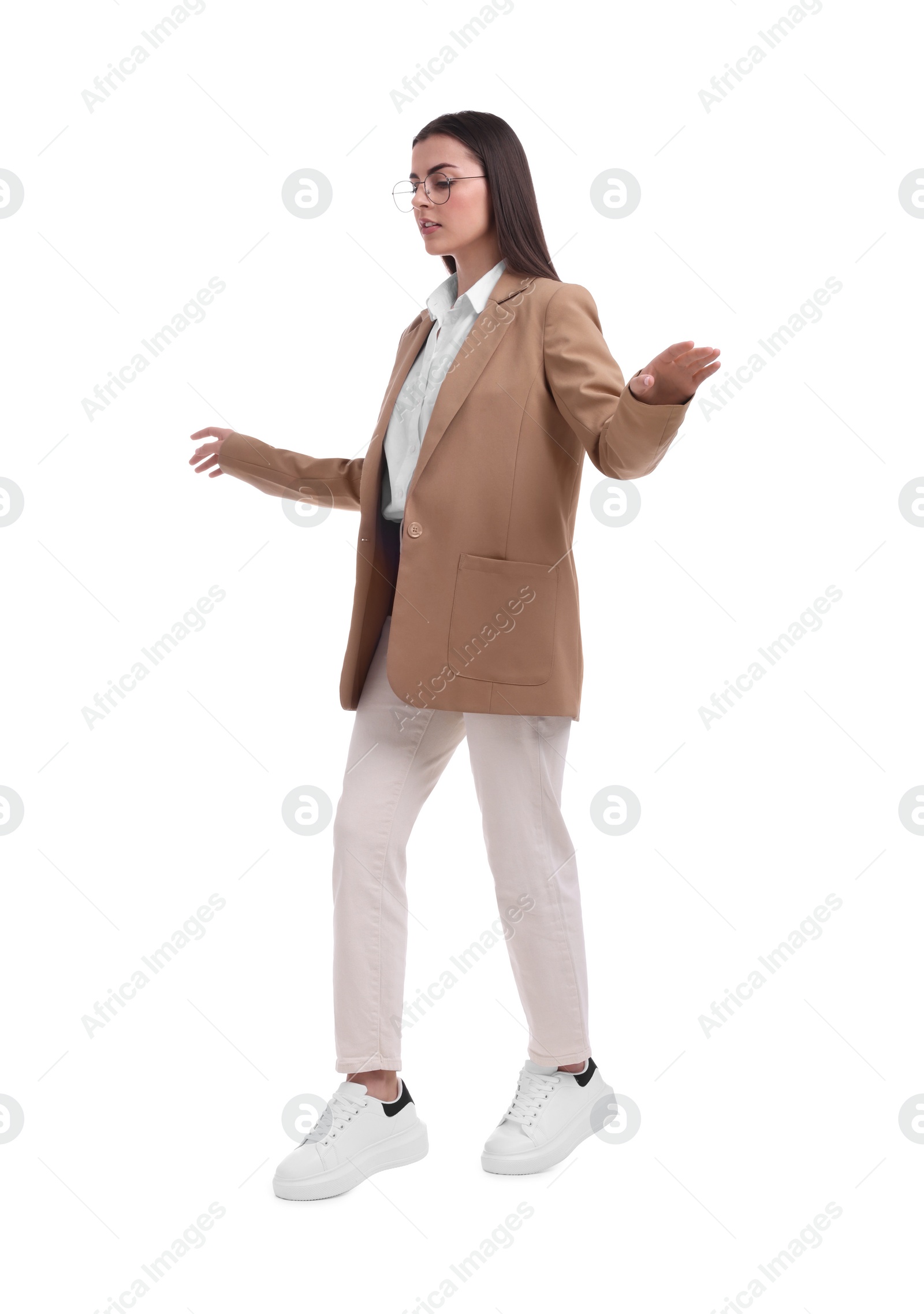 Photo of Beautiful businesswoman with glasses walking on white background