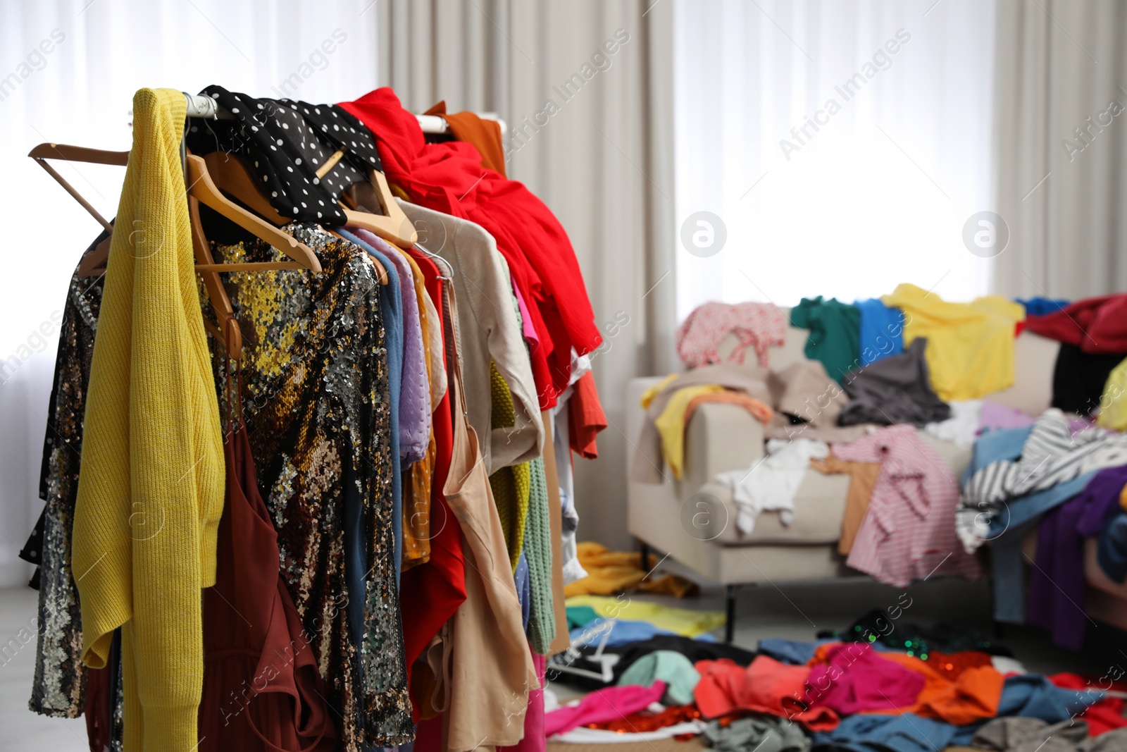 Photo of Mess of clothes all over room. Fast fashion