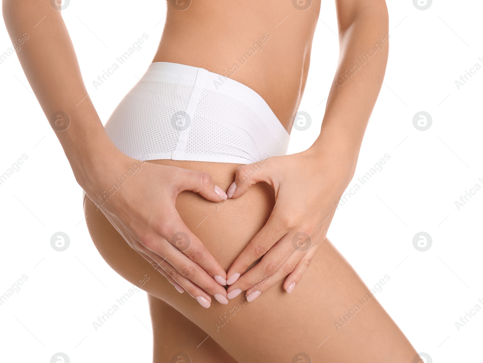 Photo of Closeup view of slim woman in underwear making heart with hands near thigh on white background. Cellulite problem concept