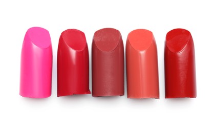 Photo of Many different bright lipsticks on white background, top view