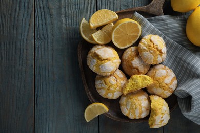 Photo of Board with delicious lemon cookies on light blue wooden table, flat lay. Space for text