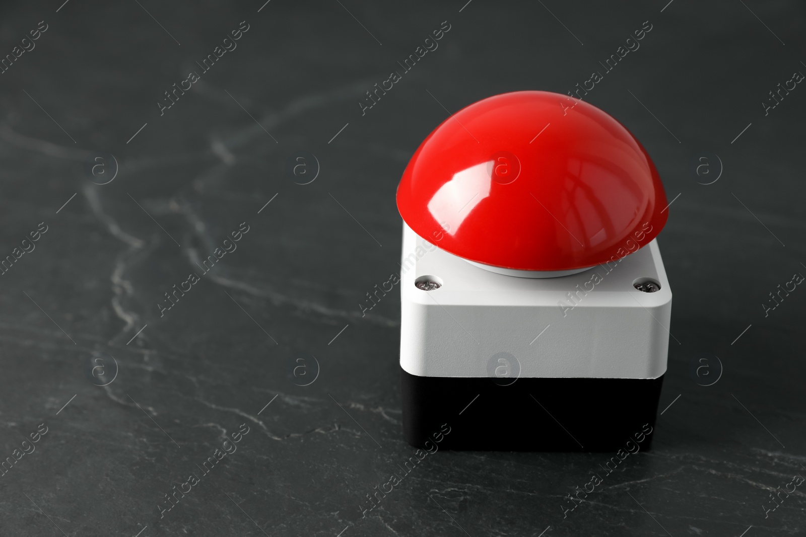 Photo of Red button of nuclear weapon on black background, closeup with space for text. War concept