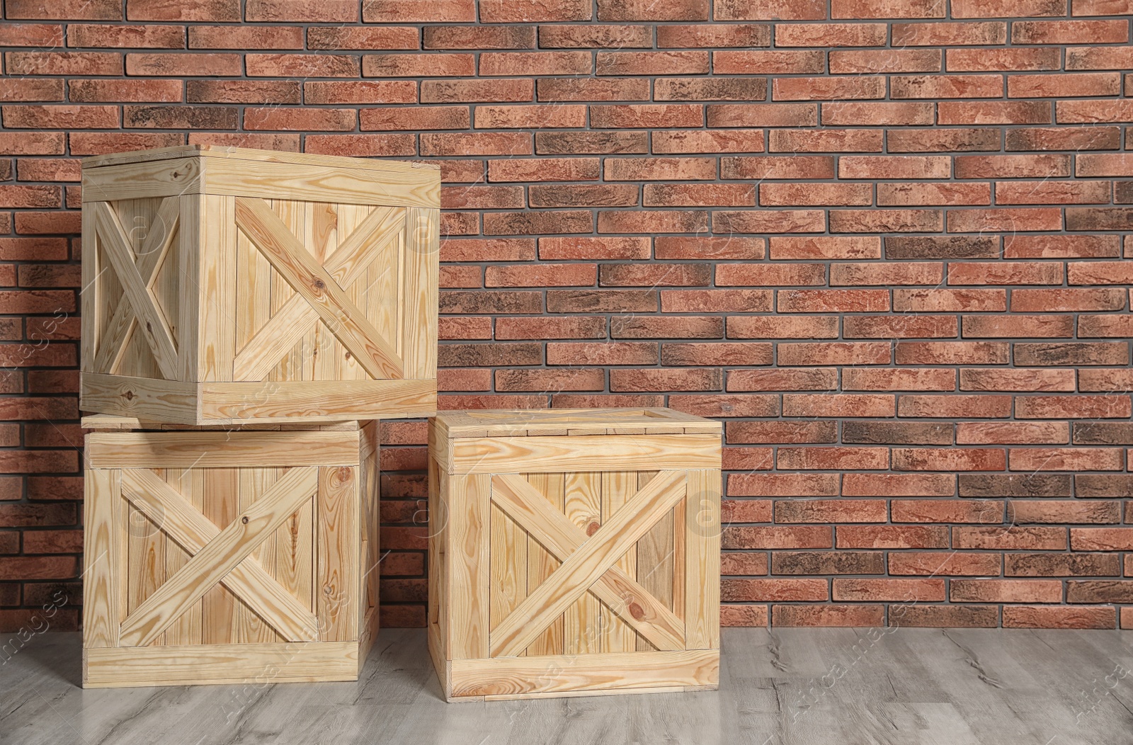 Photo of Wooden crates on floor at brick wall. Space for text