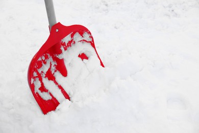Photo of Snow shovel with wooden handle outdoors. Space for text