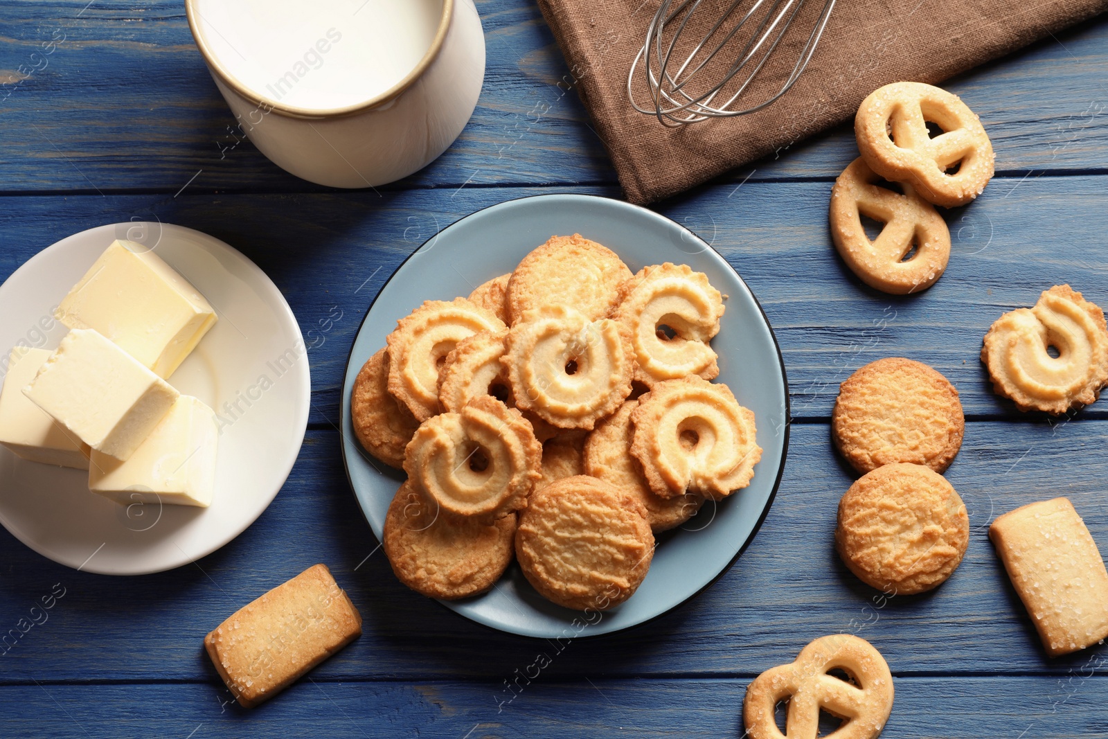 Photo of Plate with Danish butter cookies on wooden background, flat lay