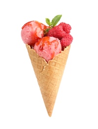 Photo of Delicious pink ice cream with raspberries, mint and syrup in waffle cone on white background